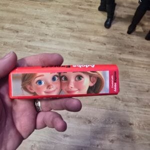 Photograph of the image I generated of my daughter and wife in a pixar style on an Adobe Express Tony's chocolate bar.